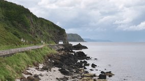 The Black Arch on The Antrim Coast Road in Northern Ireland. Part of the Causeway Coastal Route. Aerial 50fps UHD - Powered by Shutterstock - Get 15% off with code: PIKWIZARD15
