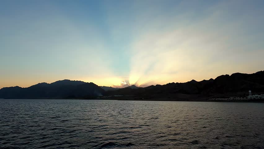 Mountains In Silhouette At Sunset At The Laguna Beach, Dahab, Egypt. wide shot