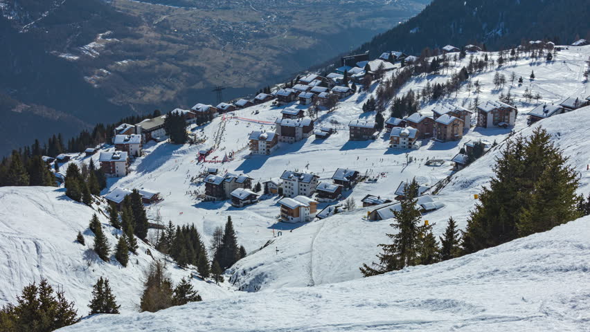 Time lapse, panoramic view on a town covered in snow. Ski resort in the Swiss Alps. Riederalp, Canton of Valais, Switzerland.
