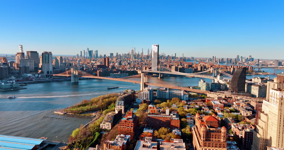 View on the Brooklyn Bridge and Manhattan Bridge over the East River in New York, the USA. Panorama of Manhattan from Brooklyn from aerial perspective on sunny day.