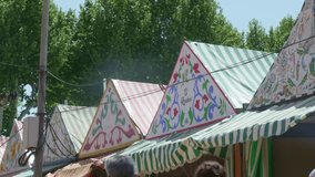 Feria of Seville: casetas, tents, people. colorful, lively, event, Seville