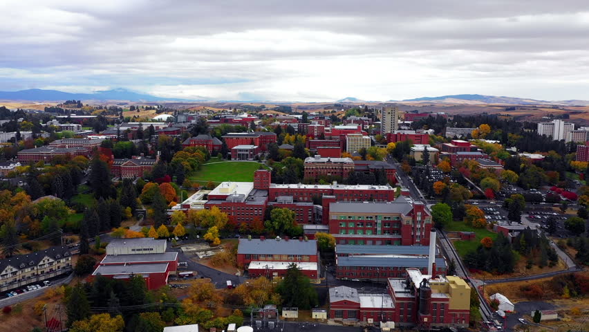 Aerial Backward Beautiful View Of Buildings In Residential Town Under Clouds During Autumn Season - Rural, Idaho