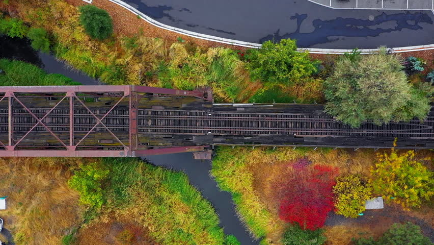 Aerial Top Panning Beautiful Shot Of Railroad Tracks Of Bridge In Town - Rural, Idaho