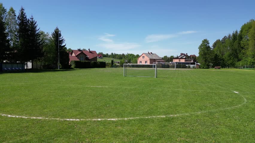 A charming local football stadium nestled in the small town of Wielopole Skrzyńskie. This quaint sports venue features a single grass pitch surrounded by a modest number of spectator seats.