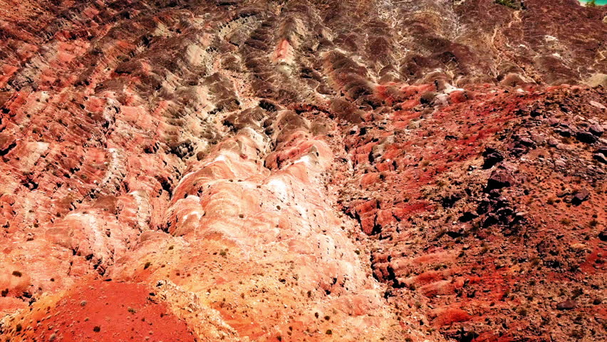 Aerial Tilt Up Shot Of Blue Lake Amidst Semi Arid Rock Formations On Sunny Day - St George, Utah