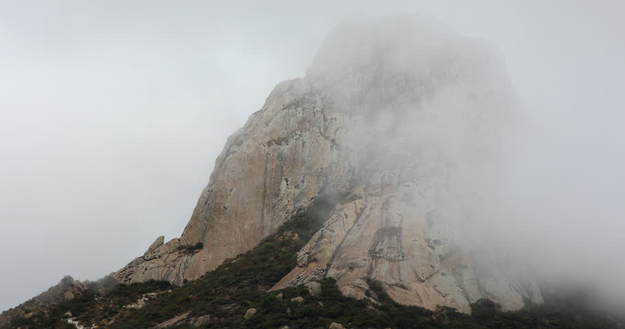 Morning fog envelopes the famous Peña de Bernal, a mountain peak of Bernal, Querétaro, Mexico.