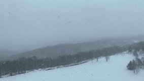 Snowing weather against a mountain backdrop at Rusutsu, Japan for Video Backgrounds
