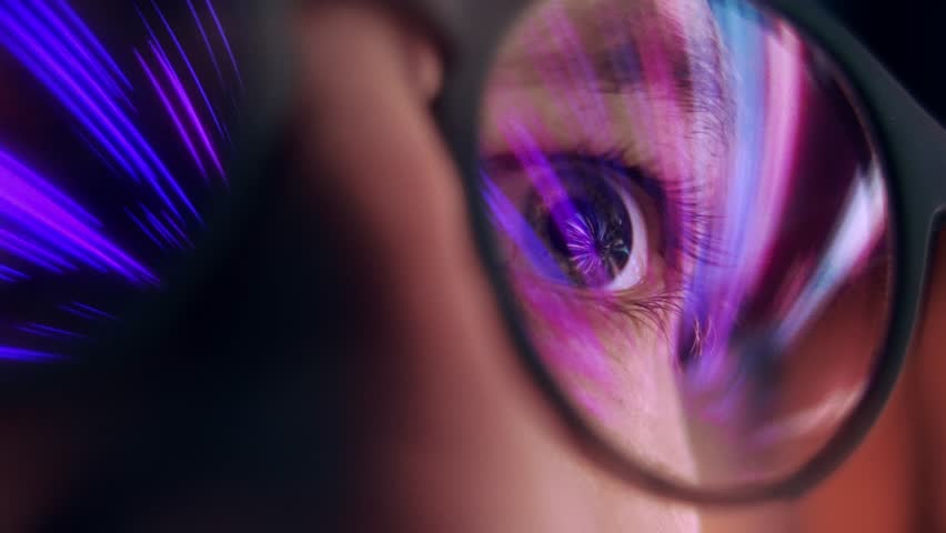 Eyes of Man in Glasses Looking at Computer Screen with Internet Projection of Shining Video. Deep Eyesight of Person Alone at Evening Spending Time Online and Seeing Moving Picture. Macro Shot View
