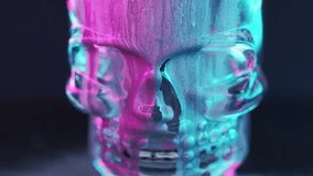 Ink skull. Neon skeleton. Death curse. Defocused fluorescent blue pink color light black glitter texture paint flow cyber head on dark abstract art background. - Powered by Shutterstock - Get 15% off with code: PIKWIZARD15