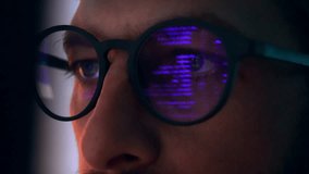 Eyes of Man in Glasses Looking at Computer Screen with Glowing Code of Web Development. Concentrated Sight of Programming Person Working Online on Internet Site. Macro Shot View of Purple Text Lines - Powered by Shutterstock - Get 15% off with code: PIKWIZARD15