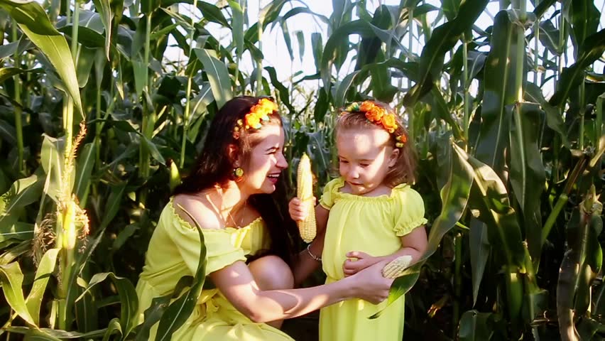 mom and daughter have fun and sing. Use corn instead of microphone