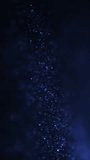 Abstract blue wave particle over dark background, digital technology concept. Vertical video.