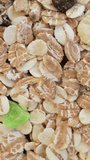 Oats and muesli rotating Close up. Healthy breakfast concept. Vertical video.