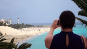 High quality video of woman making video on the vacations on canary islands in real 1080p slow motion 120fps
