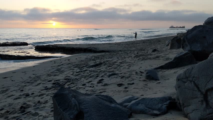 Fisherman in silhouette against the sunset.
Southern California beaches, sunsets, surfers, tide pools and palms trees at Swamis Reef Surf Park and Moonlight Beach in Encinitas California.