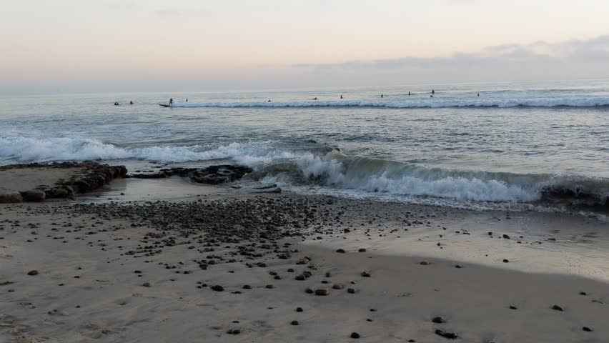 Fisherman in silhouette against the sunset.
Southern California beaches, sunsets, surfers, tide pools and palms trees at Swamis Reef Surf Park and Moonlight Beach in Encinitas California.