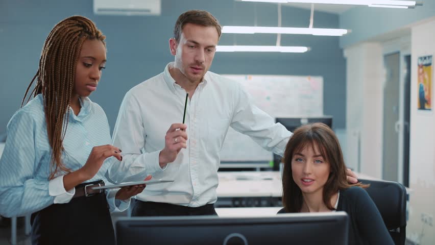 Group of colleagues gathering before meeting. Director of department pointing at mistake. Girl rewriting report and putting signature in document. Royalty-Free Stock Footage #34937557