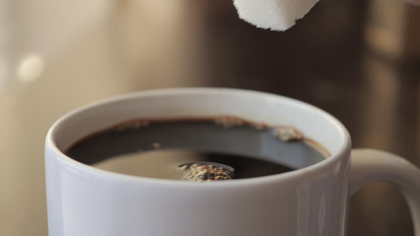 Slow Motion Hand Dropping Sugar Cube Into Black Coffee. Sugar Falling Down Into Coffee Cup. Coffee Caffeine Addiction Junk Food. Concept of Unhealthy Eating, Diabetes, Obesity, Heart Disease.  Royalty-Free Stock Footage #3493765505
