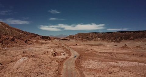 Aerial view of motorcycle adventurer riding on the salt flats desert. 4k
 – Stockvideo