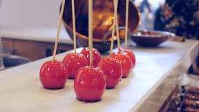 Young man preparing caramelized apples inside a shop in the center of Malaga during the Christmas period - Powered by Shutterstock - Get 15% off with code: PIKWIZARD15