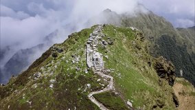 Beautiful Drone Video of Chandrashilla Himalayas mountains with clouds greater Himalayan religious temple building in Uttarakhand India