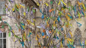 Easter tree adorned with colorful ribbons stands against the backdrop of Prague's Old Town, with historic buildings adding to the festive atmosphere of European holidays. - Powered by Shutterstock - Get 15% off with code: PIKWIZARD15