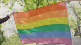 Female woman holding lgbt gay pride flag in hands, close up - Powered by Shutterstock - Get 15% off with code: PIKWIZARD15