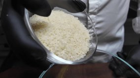 Pours rice into a glass bowl. Slow motion - Powered by Shutterstock - Get 15% off with code: PIKWIZARD15