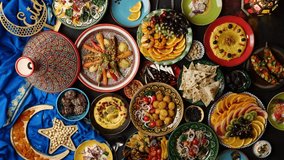 Eid Mubarak, Muslim family cooking, eating, praying and celebrating together. Traditional meals from the Arab world, everyone sits together - Powered by Shutterstock - Get 15% off with code: PIKWIZARD15