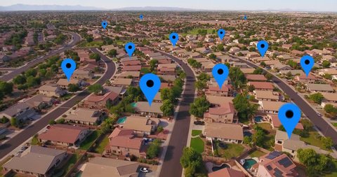 An aerial establishing shot of a typical Arizona residential neighborhood with GPS markers over random homes. Phoenix suburbs.  	