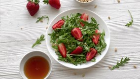 Vitamin salad of strawberry with arugula. Vegan food. Summer salad. 
