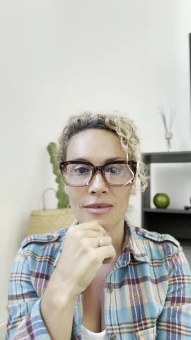 Friendly adult woman speaking cheerful on camera in videocall connection. Online friendship in remote video call wearing glasses. One lady talk at the camera of laptop or phone mobile app. Zoom Royalty-Free Stock Footage #3494195839