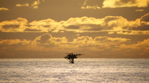 Beautiful mystic sunrise and offshore platform in the middle of the ocean
