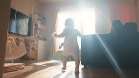 baby toddler first steps. baby son takes first steps around the room to his father sitting by the window glare of the sun learns to walk. happy family kid concept. toddler first dream steps - Powered by Shutterstock - Get 15% off with code: PIKWIZARD15