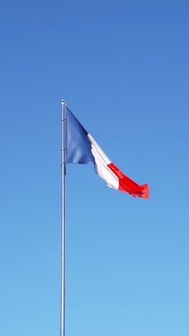 French flag against blue sky. Flag of France. Vertical video