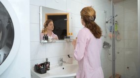 Beautiful caucasian middle aged woman uses foundation, concealer, and a correcting pencil in the bathroom - Powered by Shutterstock - Get 15% off with code: PIKWIZARD15