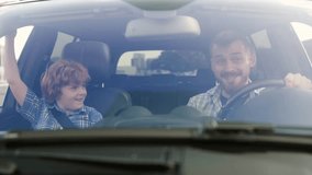 Father and little son giving high five while sitting in the car. Slow motion - Powered by Shutterstock - Get 15% off with code: PIKWIZARD15