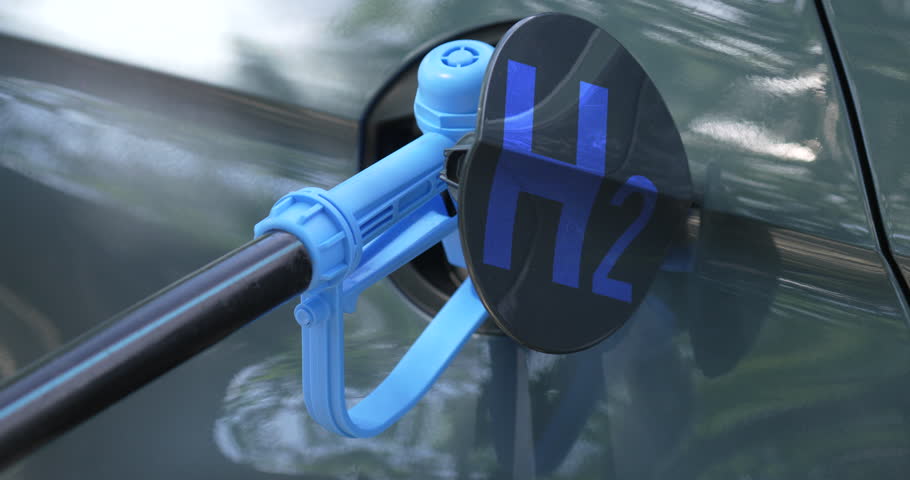 Close up of fuel cell car with connected hydrogen fueling nozzle