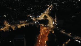 Aerial drone video above city streets during night