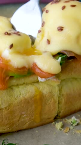 Eggs Benedict- toasted English muffins, poached eggs, and delicious buttery hollandaise sauce. High quality photo Royalty-Free Stock Footage #3494364965