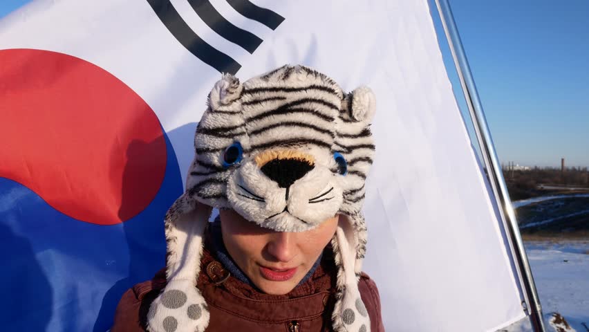 woman in hat on the background of the flag of South Korea.