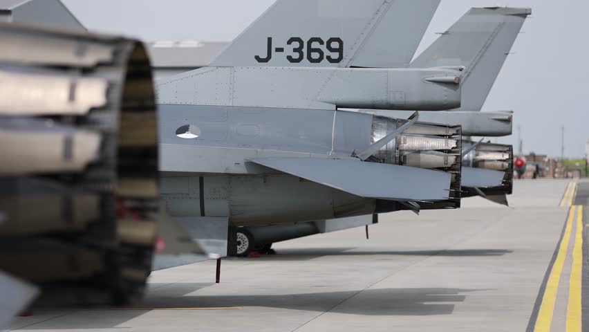 Fighter jet exhaust nozzle detail on a lot of fighter airplanes in parking position. 