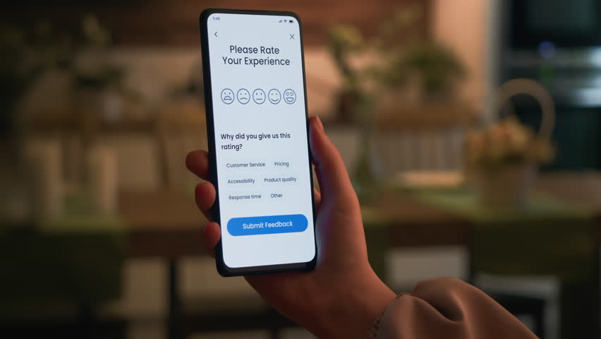 Leaving positive customer feedback via an application on a smartphone. Good customer experience and nice performance. Customer satisfaction concept.