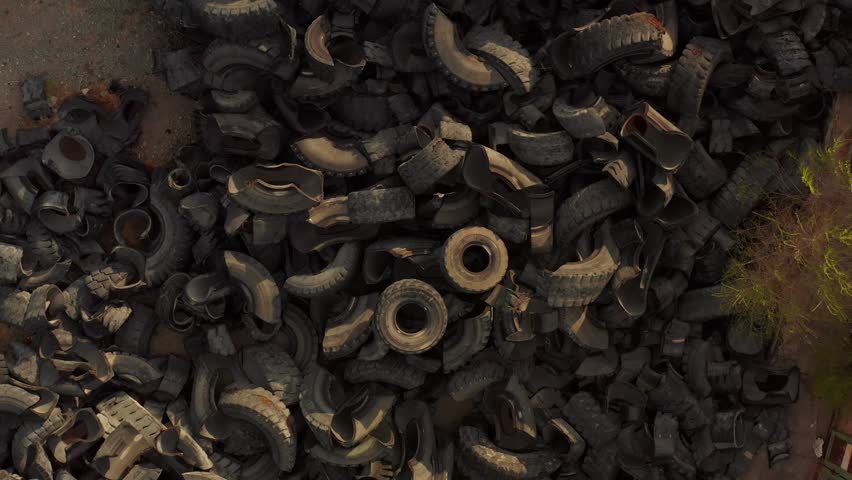 Drone view, old tires being industrial garbage, industrial landfill for processing. Close-up. Environment disaster concept. Environmental pollution. 