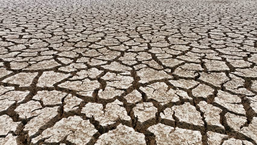 Witness the aerial spectacle of parched land, a poignant symbol of drought's devastation. It underscores the critical call for sustainable water management to stem environmental erosion.
