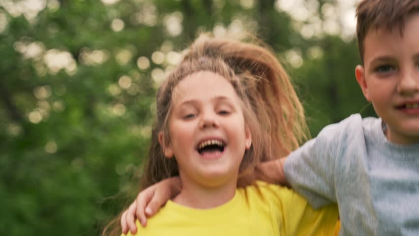 Happy family concept.group of children run and jump in park outdoors.unity.children laugh and hug in nature.sunny day.dream of happy child. silhouette of children in summer in the park. way to success
