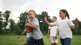 Happy family concept.children playing rugby together in park outdoors.group of children run on green grass and play American football. family playing rugby in a forest park outdoors. children's dream - Powered by Shutterstock - Get 15% off with code: PIKWIZARD15