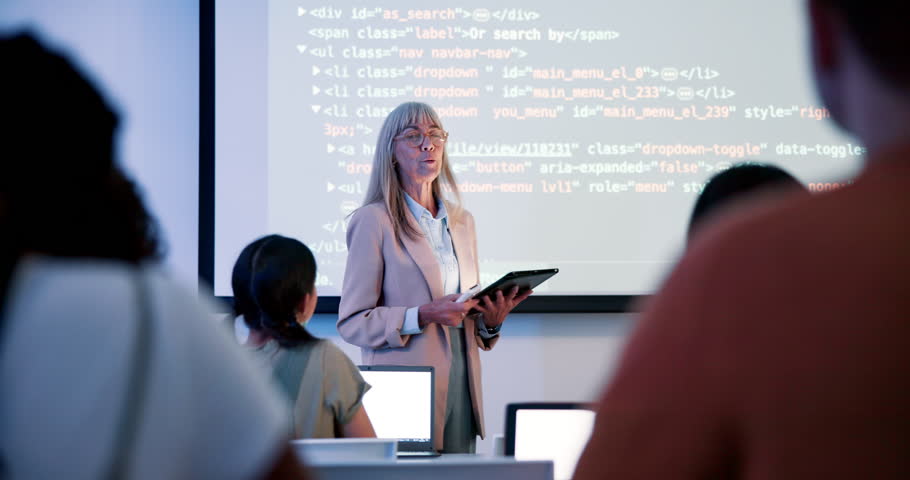 Female lecturer, coding and screen in class for education with html, teaching with technology for web development. Woman, teacher and tablet for projection to students, introduction to programming