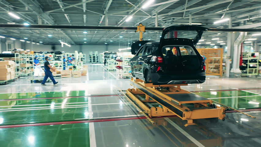 Car assembly line, automobile industry concept. Unfinished carcasses of cars kept in a factory unit