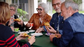 Group of residents of a nursing home taking breakfast. Mature friends at geriatric coffee bakery bar. Happy Caucasian senior citizens people having fun together at cappuccino restaurant cafe terrace - Powered by Shutterstock - Get 15% off with code: PIKWIZARD15
